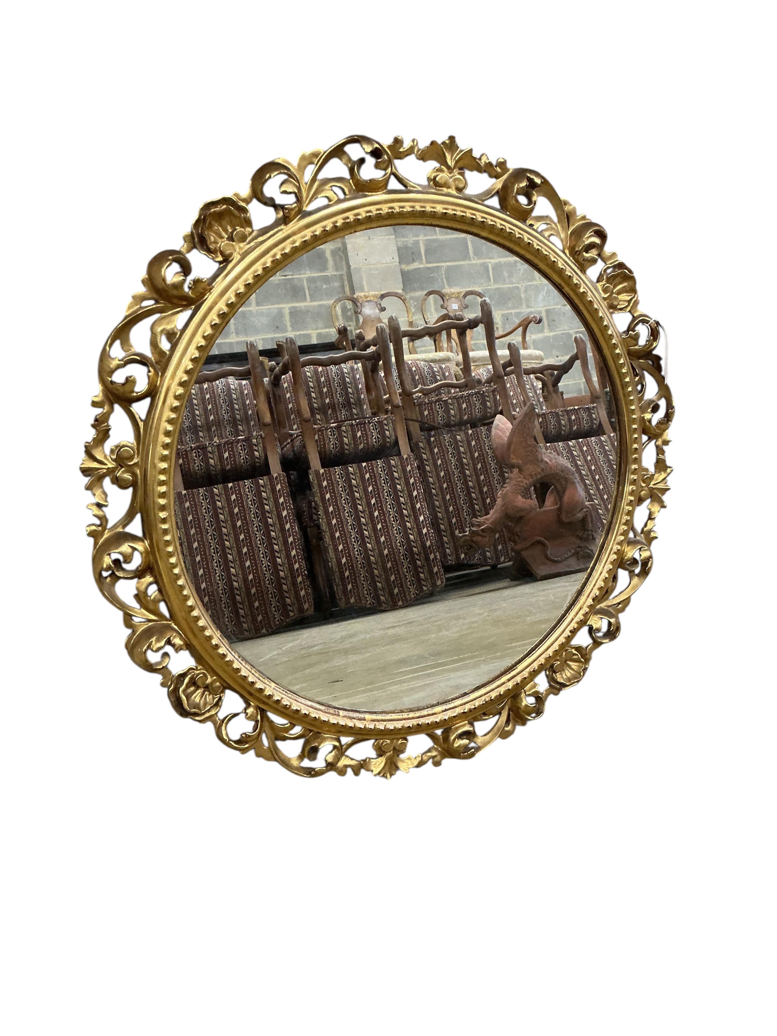 A Florentine style circular carved giltwood wall mirror, diameter 64cm